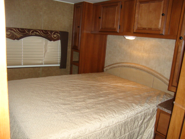 The Coachmen 320BH Class C Bunkhouse offers a comfortable bed setup, ensuring a restful night's sleep for travelers