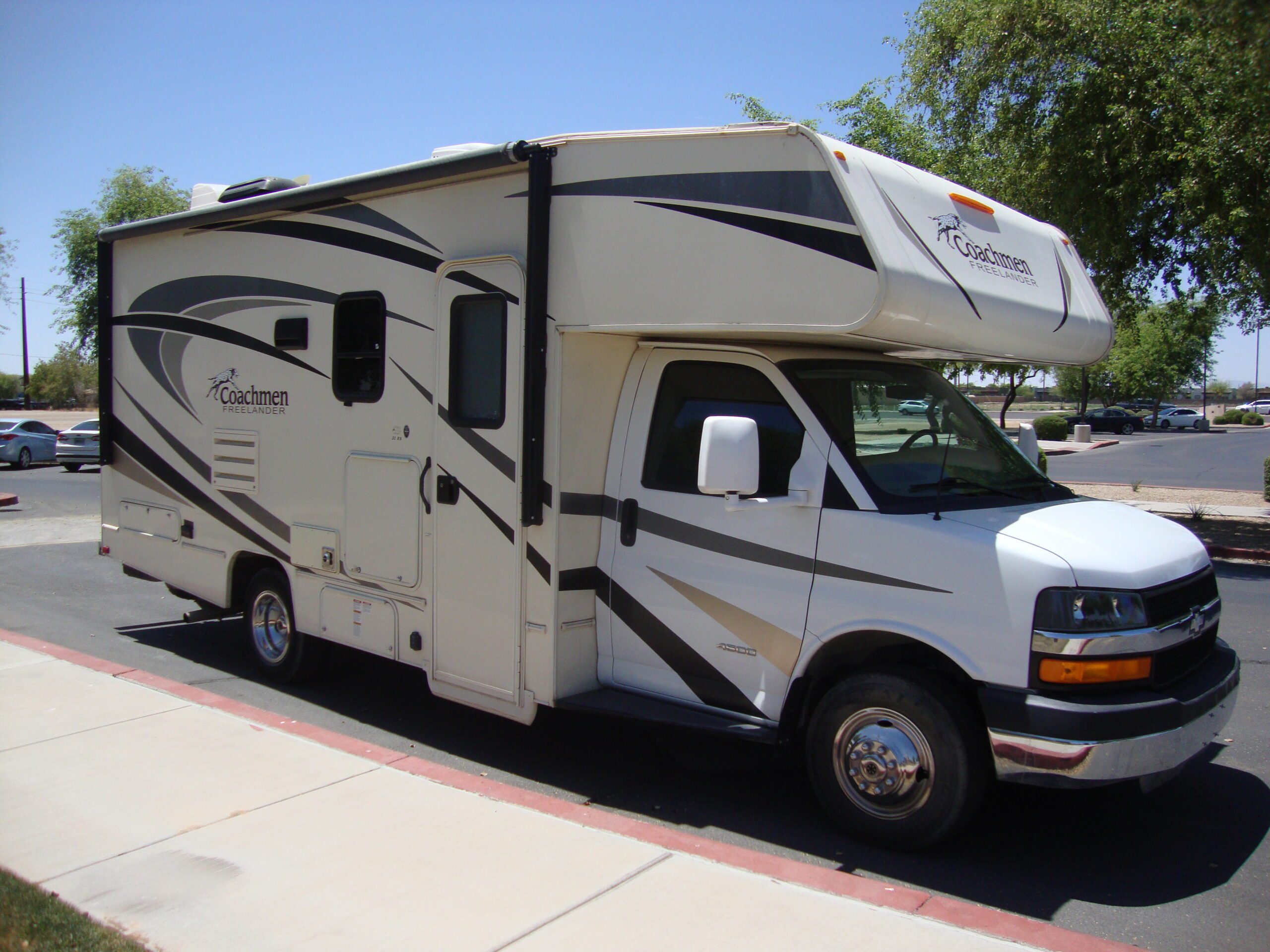 The Coachmen Freelander 21-RS is parked on the road, showcasing its compact and versatile design