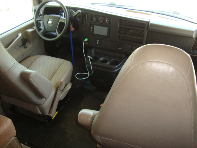 The front driver seat and the seat next to it in the Coachmen Freelander 21-RS offer comfortable seating options for the driver and passenger, ensuring a pleasant travel experience