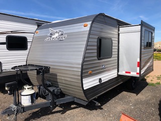 Exterior view of a travel trailer, highlighting its design, windows, and overall structure