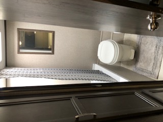 Travel trailer equipped with toilet facilities, showing the interior setup with a dedicated bathroom area